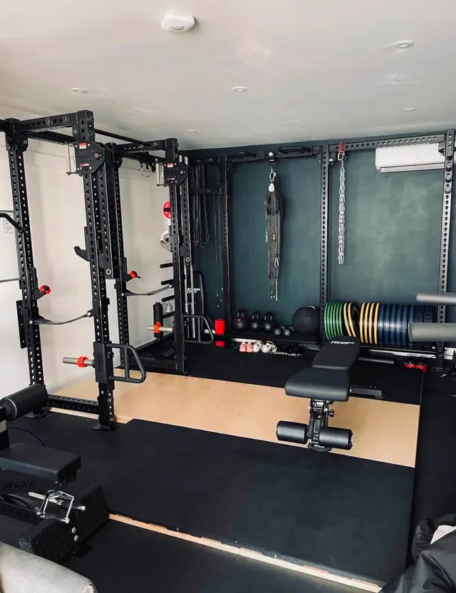 Rubber gym flooring around a wooden lifting platform in Rob’s gym