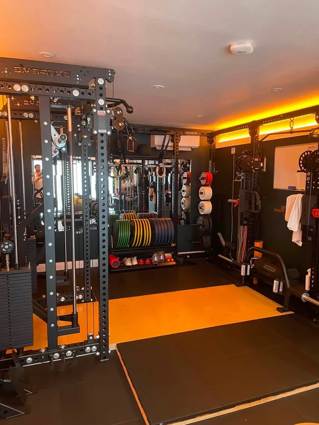 Plates, bars and small accessories stored around Rob’s lifting area